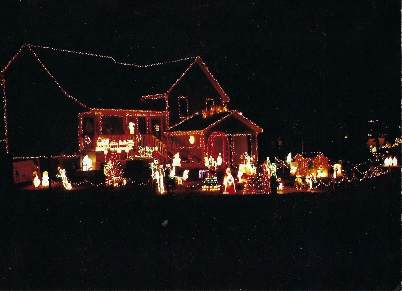 The Kearney house at night in 2006, the roofline and windows outlined in lights