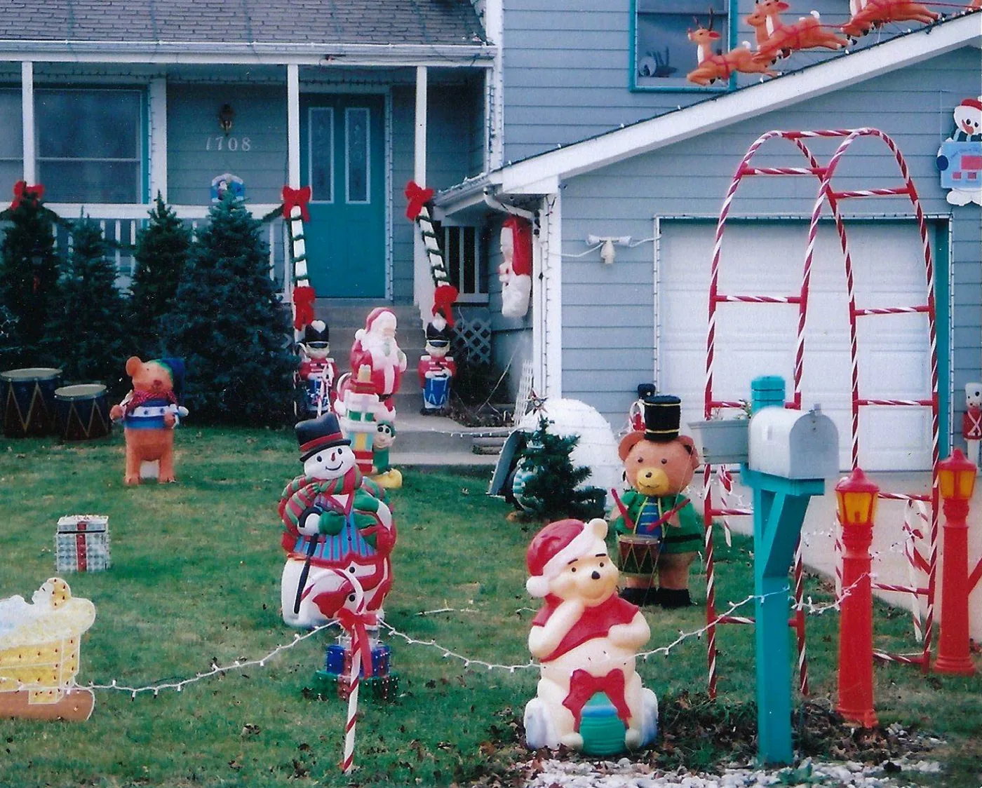 Blow molds by the front door under a candy cane arch in 2009